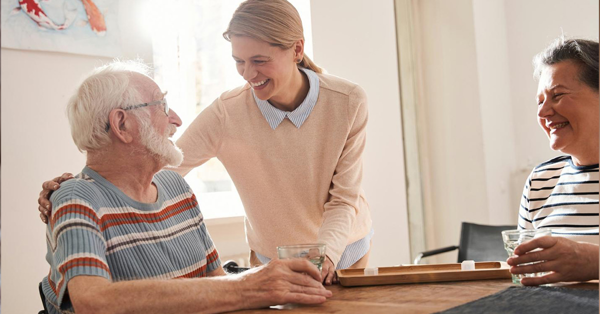 smiling caretaker with elderly man